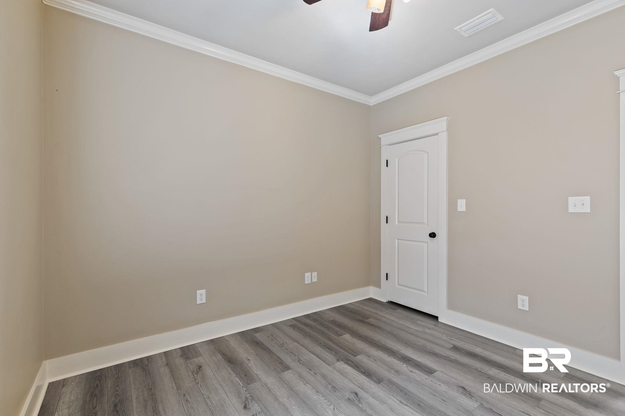 9584 Sanibel Loop Daphne, AL 36526 - Photo 36 of 48 Spare room with ornamental molding, light wood-style flooring, and a ceiling fan