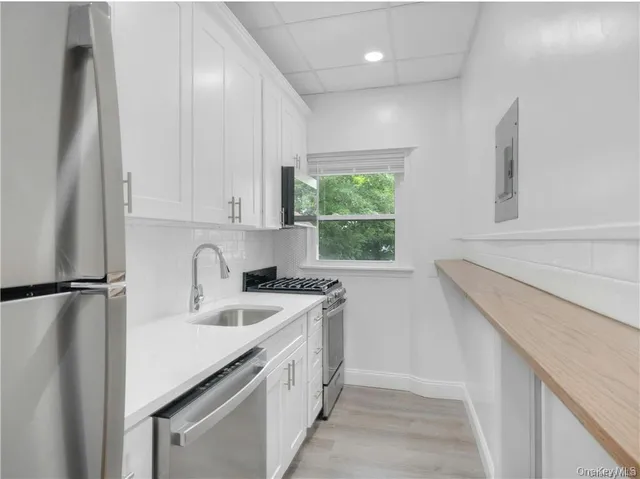 a kitchen with a sink a stove a refrigerator and window