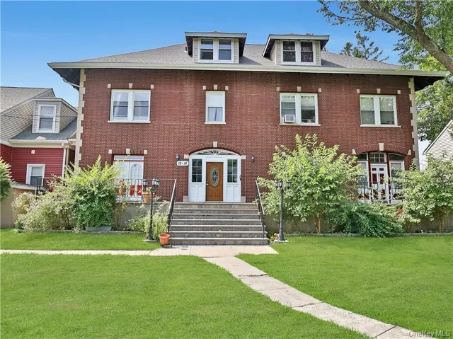 a front view of a house with garden