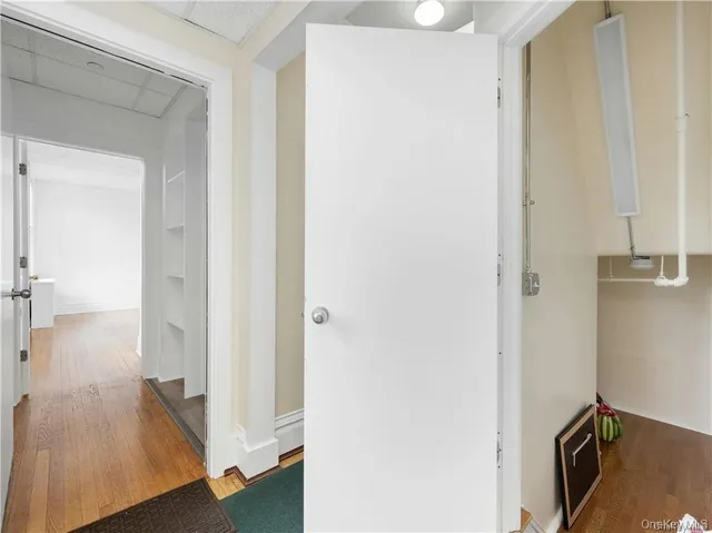 a view of a hallway with wooden floor