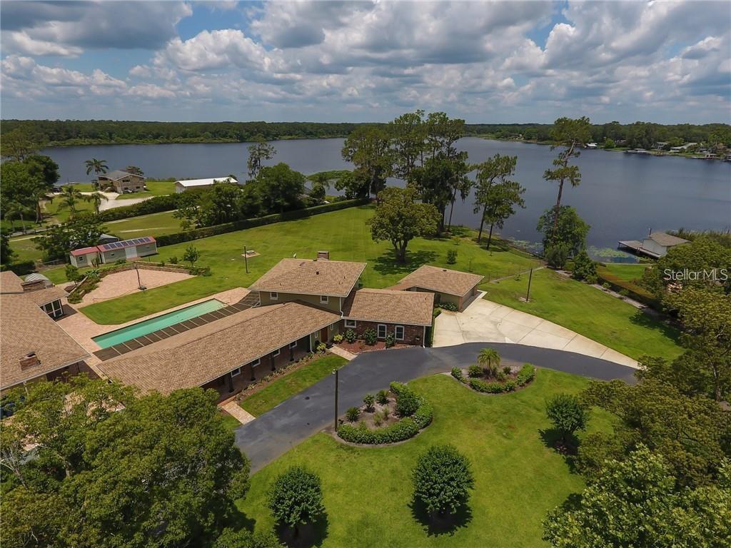 an aerial view of a house with yard swimming pool and outdoor seating