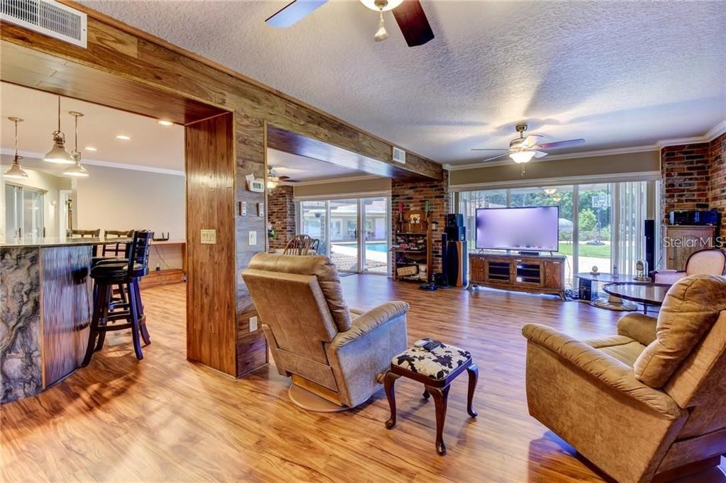 910 North Kepler Road DeLand, FL 32724 - Photo 11 of 52 a living room with furniture and a flat screen tv
