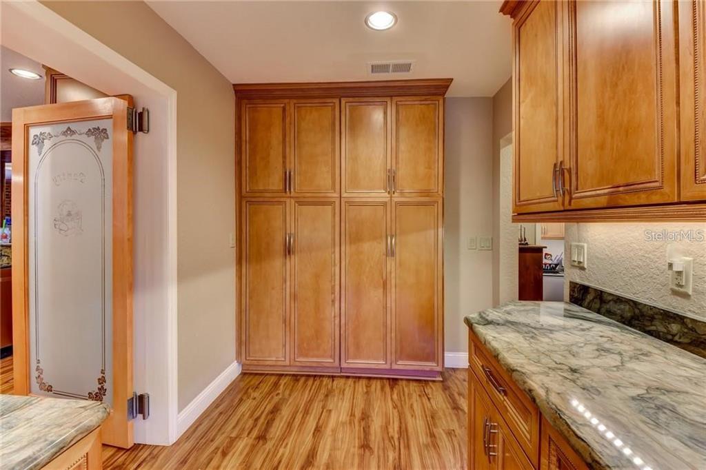 910 North Kepler Road DeLand, FL 32724 - Photo 14 of 52 a bathroom with a granite countertop sink and a mirror