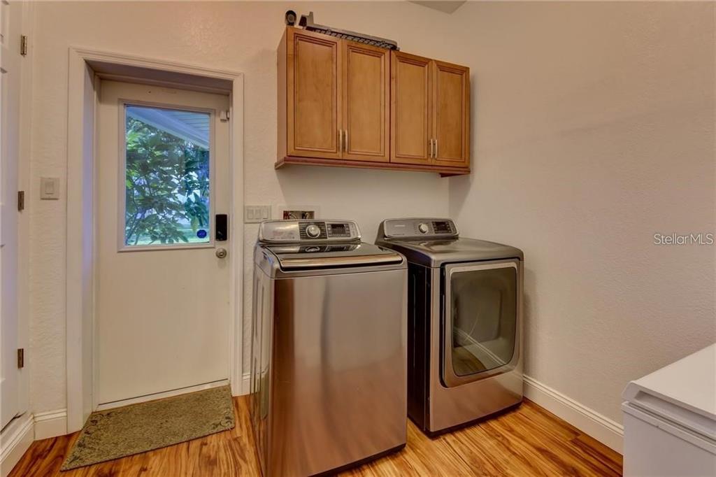 910 North Kepler Road DeLand, FL 32724 - Photo 16 of 52 a utility room with wooden floor washer and dryer