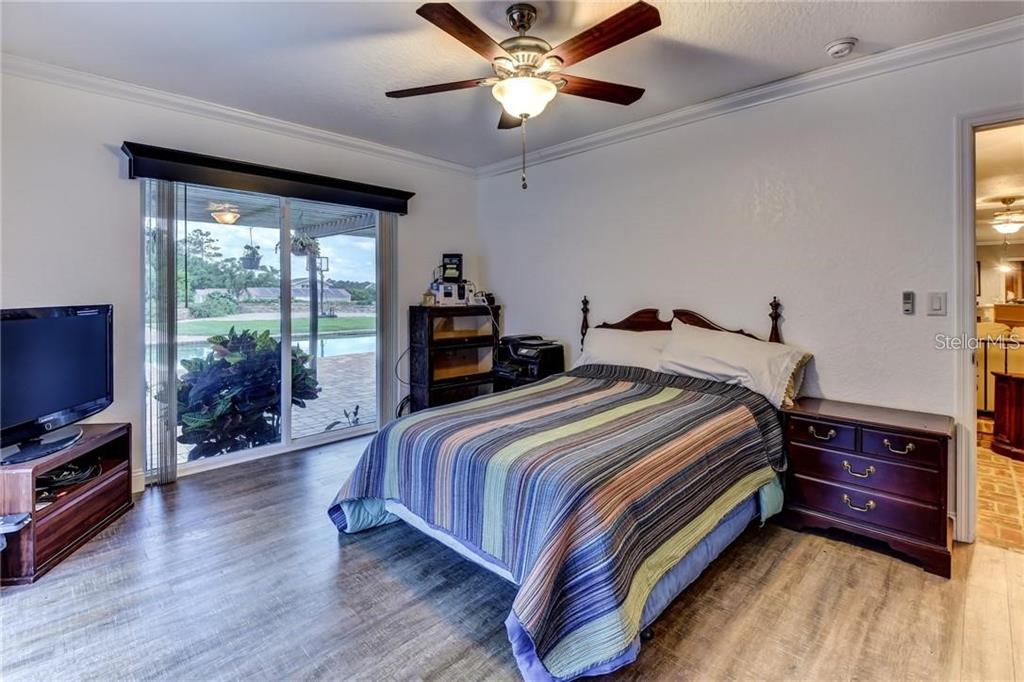 910 North Kepler Road DeLand, FL 32724 - Photo 17 of 52 a bedroom with a bed and wooden floor
