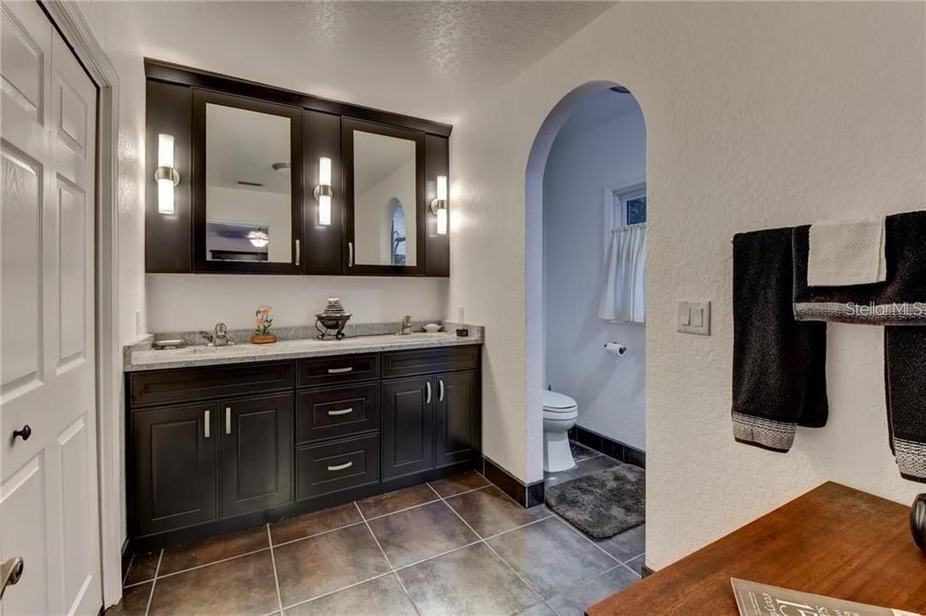 910 North Kepler Road DeLand, FL 32724 - Photo 18 of 52 a bathroom with a double vanity sink and a mirror