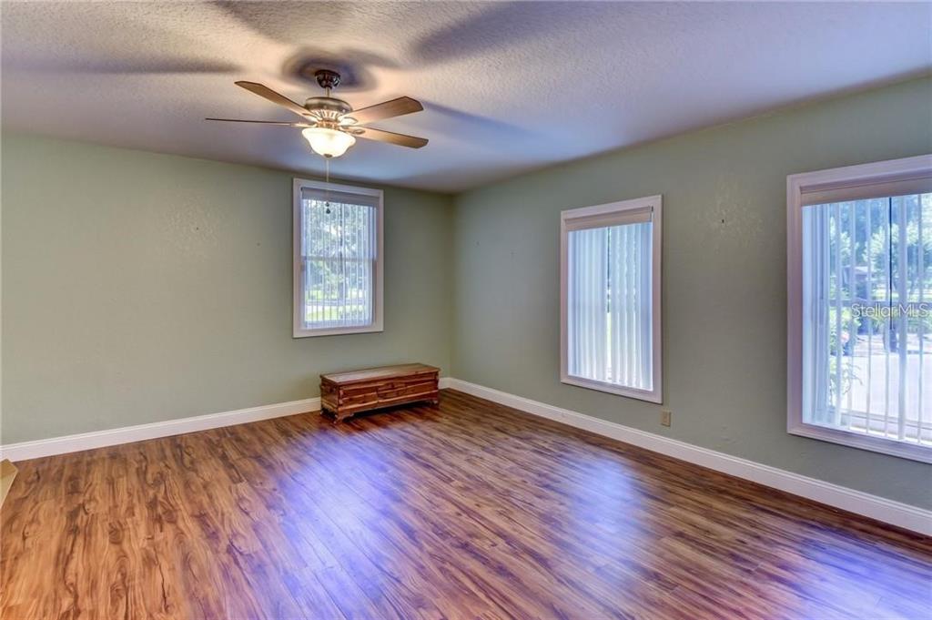 910 North Kepler Road DeLand, FL 32724 - Photo 19 of 52 a view of an empty room with wooden floor and a window