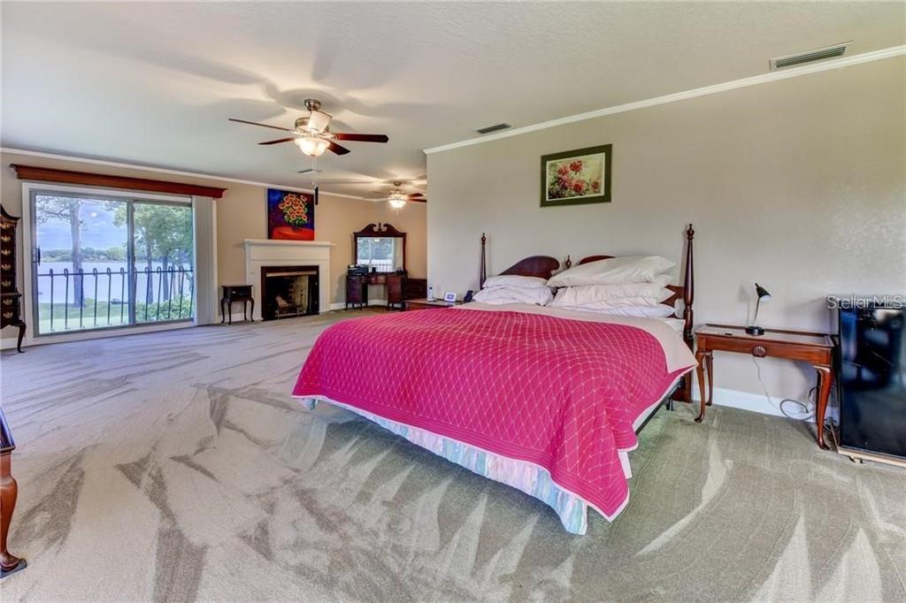 910 North Kepler Road DeLand, FL 32724 - Photo 21 of 52 a bed room with a bed and a fireplace