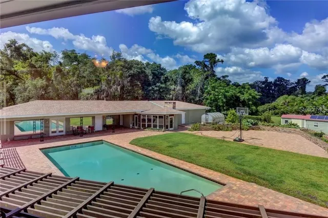 a view of swimming pool is middle in the garden