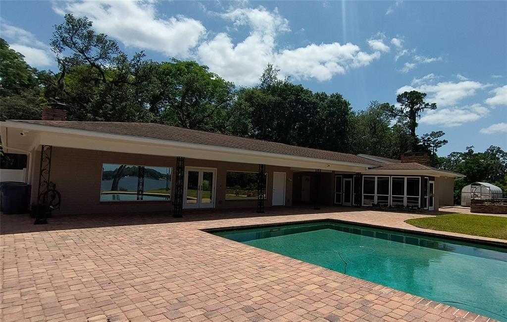 910 North Kepler Road DeLand, FL 32724 - Photo 26 of 52 a view of a house with a swimming pool and a yard