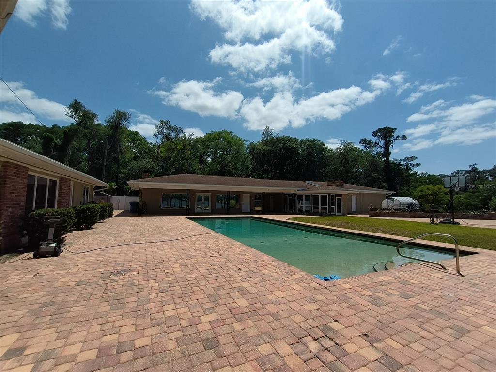 910 North Kepler Road DeLand, FL 32724 - Photo 27 of 52 a view of swimming pool with seating space and barbeque oven
