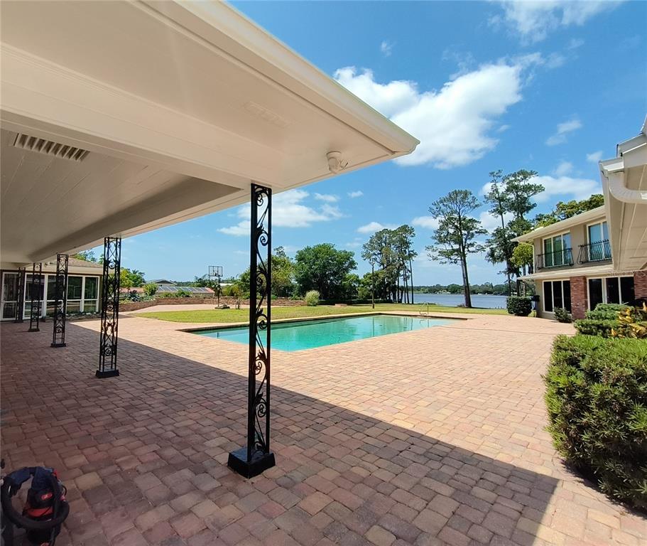 910 North Kepler Road DeLand, FL 32724 - Photo 28 of 52 a view of a swimming pool with an outdoor seating