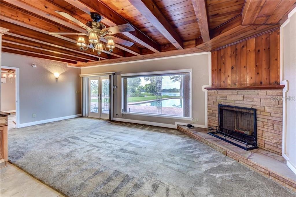 910 North Kepler Road DeLand, FL 32724 - Photo 29 of 52 a view of an empty room with a fireplace and a window