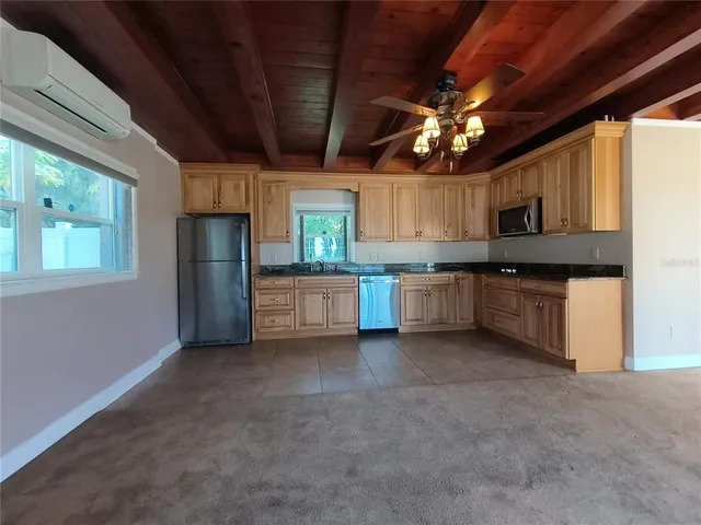 a large kitchen with cabinets and stainless steel appliances