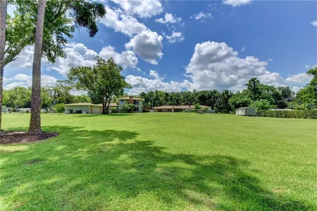 an aerial view of a houses with yard