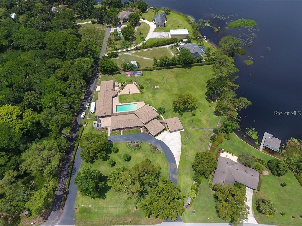 910 North Kepler Road DeLand, FL 32724 - Photo 51 of 52 an aerial view of a house with a yard and lake view