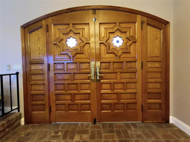 a kitchen with stainless steel appliances granite countertop table chairs stove and wooden floor