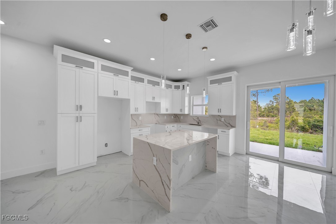 1153 Countess Avenue Lehigh Acres, FL 33974 - Photo 21 of 37 a large kitchen with a large window