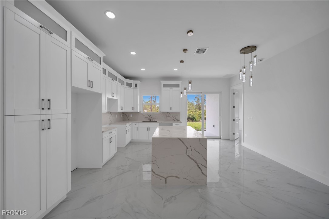 1153 Countess Avenue Lehigh Acres, FL 33974 - Photo 23 of 37 a view of kitchen with furniture and refrigerator