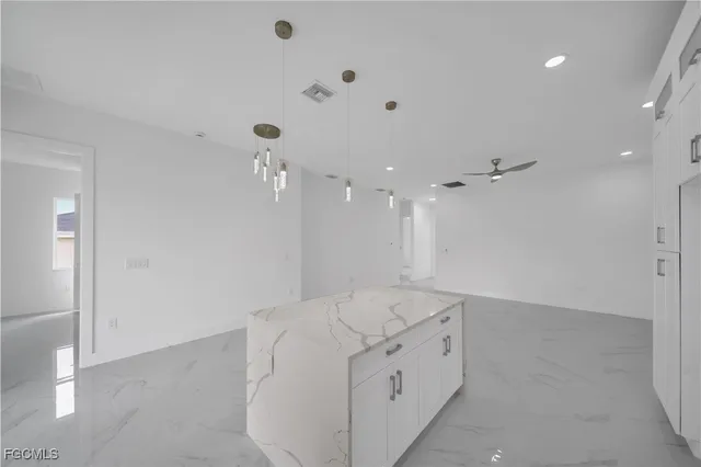 a spacious bathroom with a granite countertop sink mirror and shower