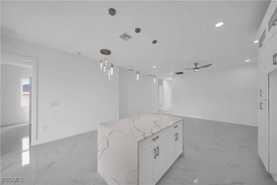 1153 Countess Avenue Lehigh Acres, FL 33974 - Photo 25 of 37 a spacious bathroom with a granite countertop sink mirror and shower