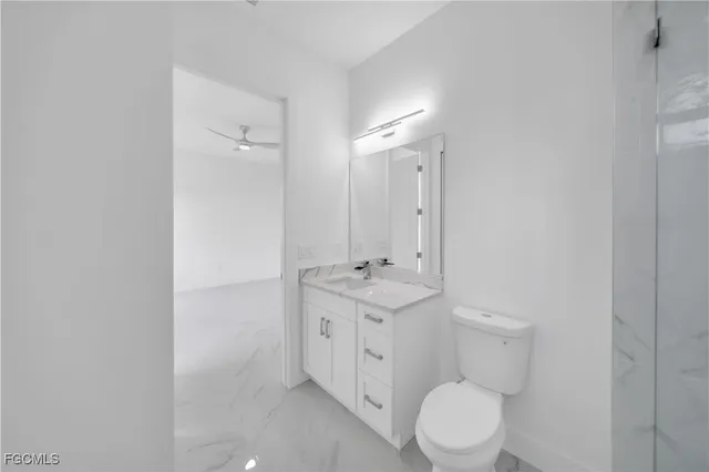 a bathroom with a toilet a sink and a mirror