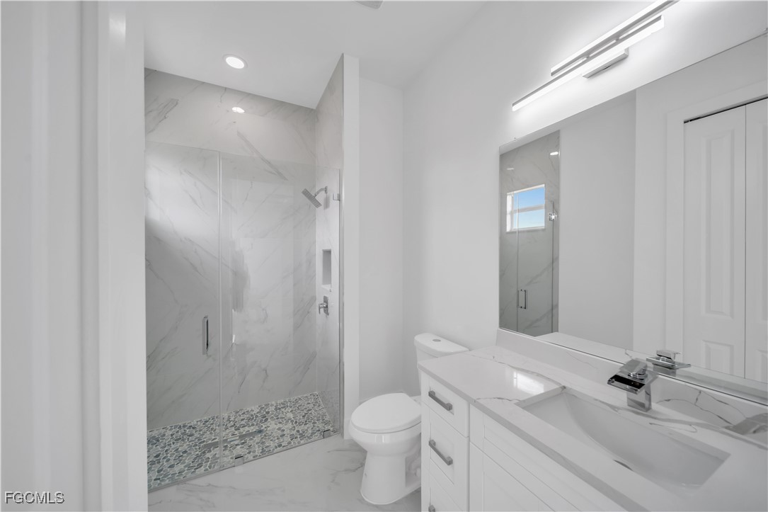 1153 Countess Avenue Lehigh Acres, FL 33974 - Photo 34 of 37 a bathroom with a sink toilet and shower