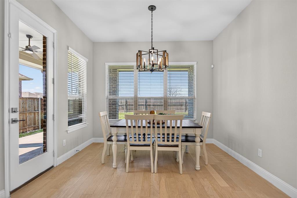 6829 Danridge Road Rowlett, TX 75089 - Photo 5 of 28 a view of a dining room with furniture window and wooden floor
