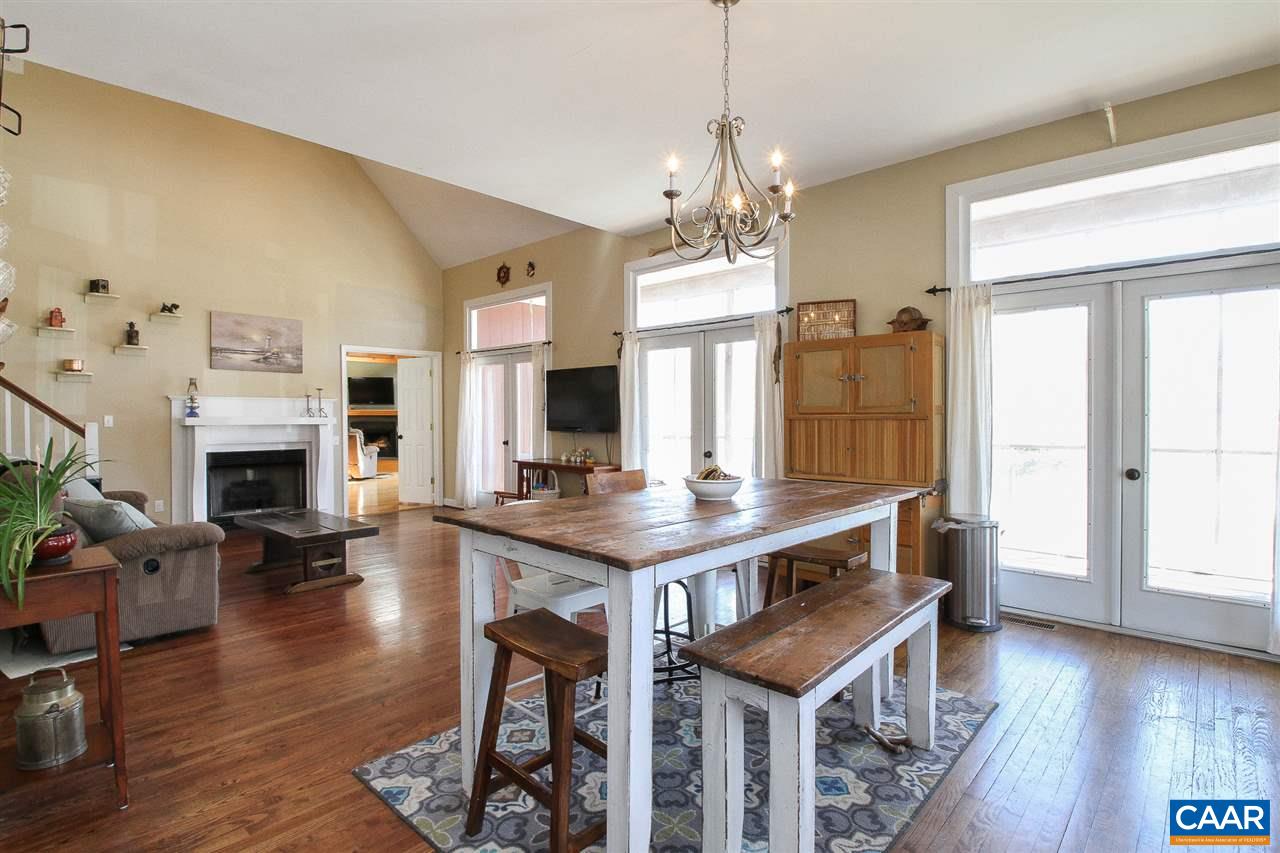 364 Lake Road Troy, VA 22974 - Photo 4 of 25 a view of a kitchen area kitchen island dining table wooden floor and a fireplace