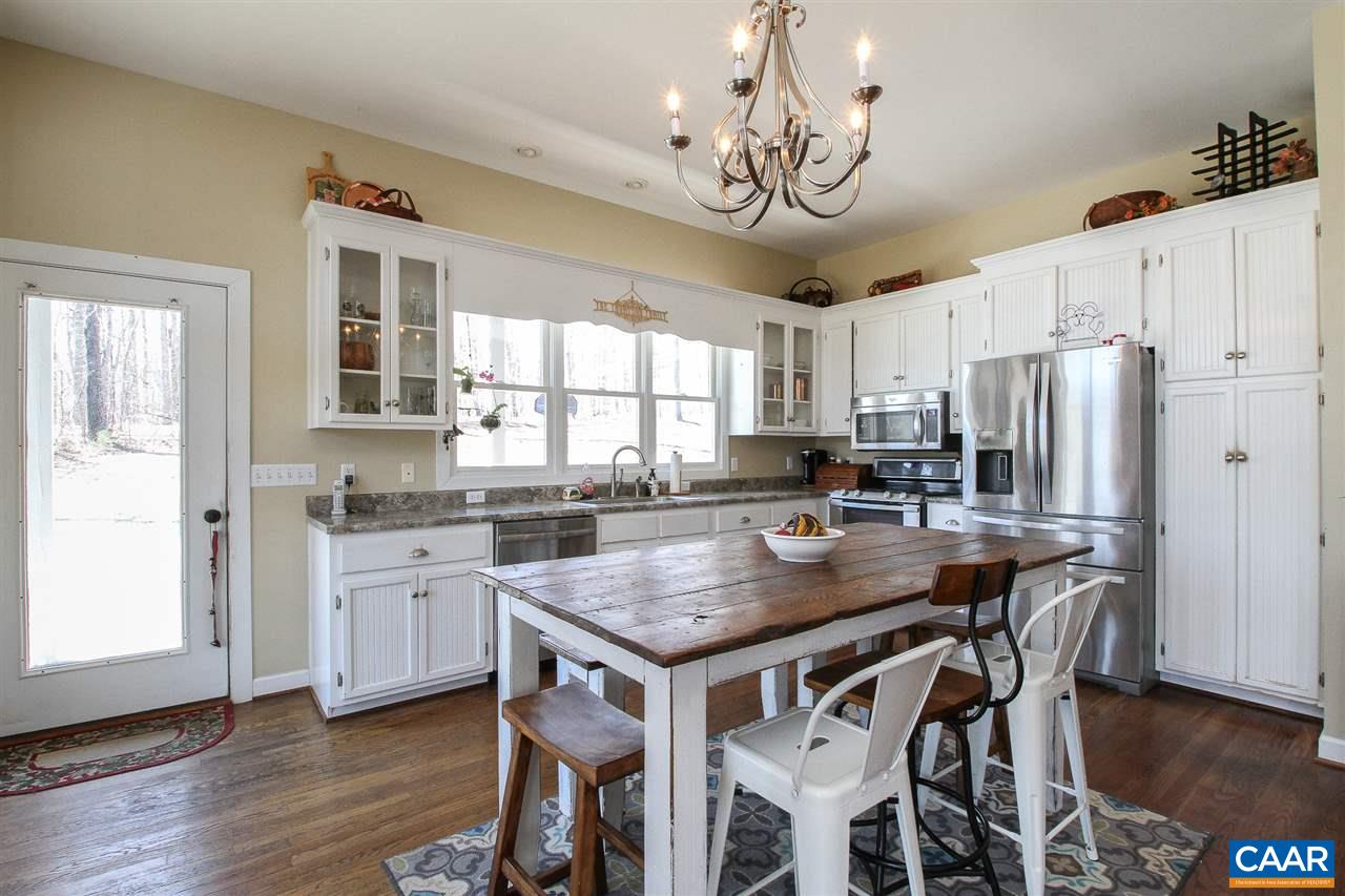 364 Lake Road Troy, VA 22974 - Photo 5 of 25 a kitchen with stainless steel appliances granite countertop a dining table chairs stove refrigerator and cabinets