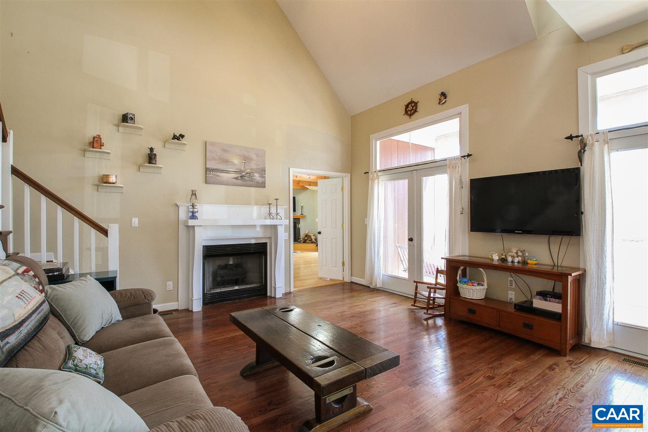 364 Lake Road Troy, VA 22974 - Photo 8 of 25 a living room with furniture flat screen tv and a fireplace