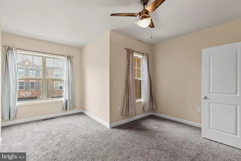 an empty room with windows and closet