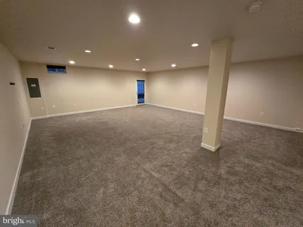 an empty room with a projector and screen