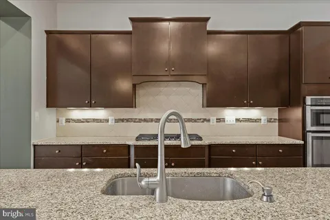 a kitchen with a sink and a refrigerator