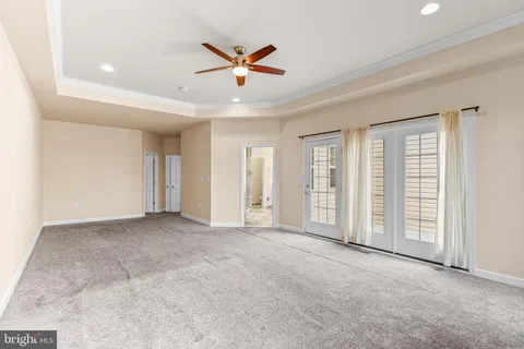 an empty room with closet and windows