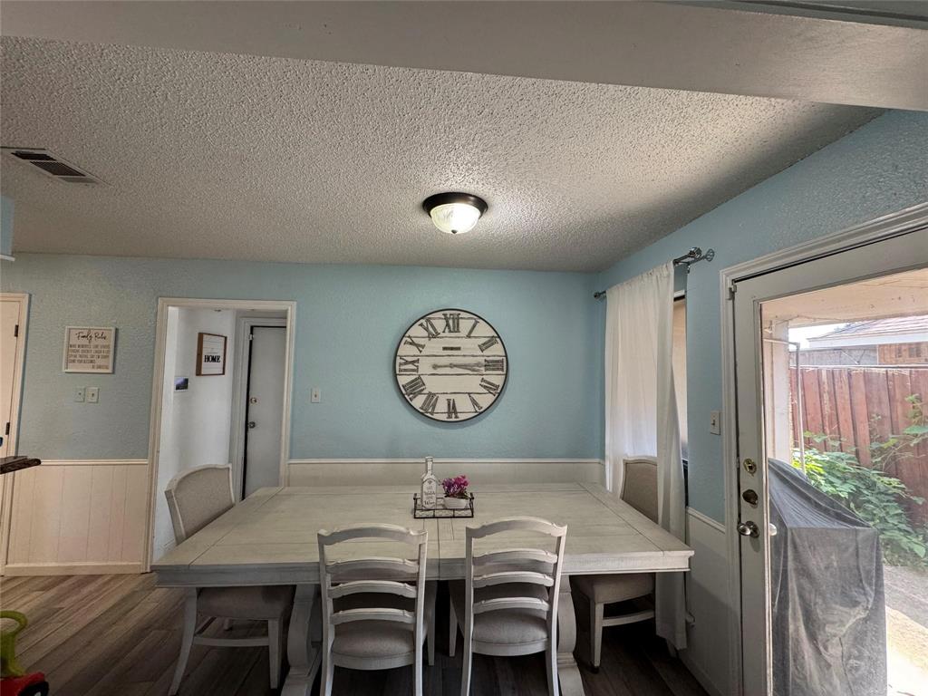 2412 Ridgestone Drive Dallas, TX 75287 - Photo 13 of 23 a view of a dining room with furniture and wooden floor