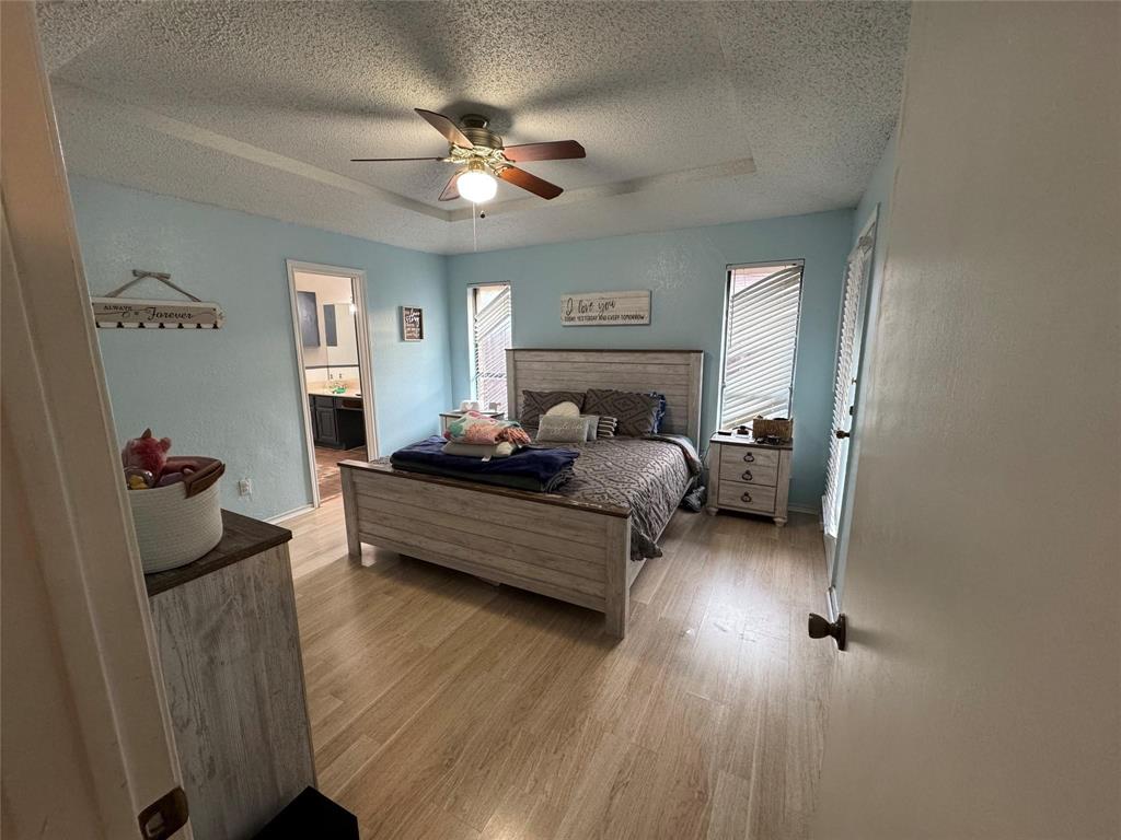 2412 Ridgestone Drive Dallas, TX 75287 - Photo 18 of 23 a bedroom with furniture and a mirror
