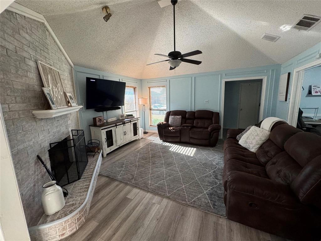 2412 Ridgestone Drive Dallas, TX 75287 - Photo 3 of 23 a living room with furniture and a flat screen tv