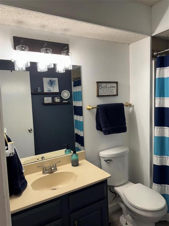 2412 Ridgestone Drive Dallas, TX 75287 - Photo 7 of 23 a bathroom with a sink toilet and mirror