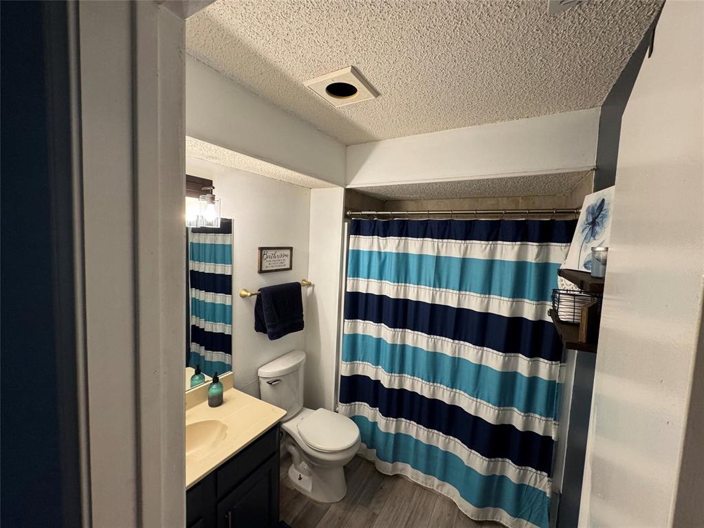 2412 Ridgestone Drive Dallas, TX 75287 - Photo 8 of 23 a bathroom with a sink toilet and shower