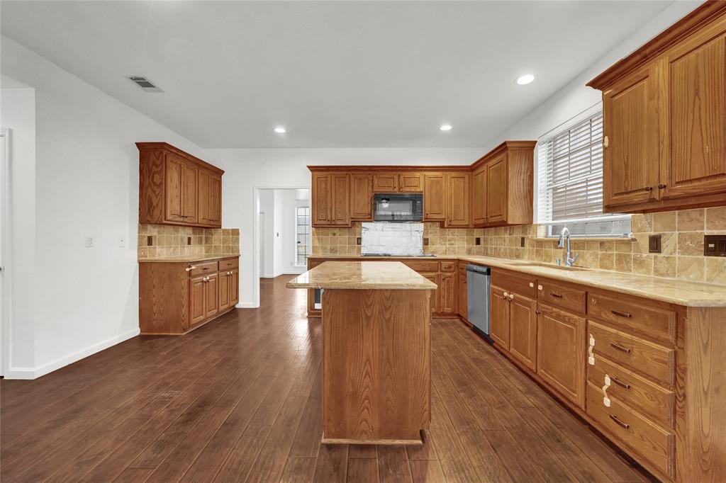 8105 Eagle Drive Rowlett, TX 75088 - Photo 11 of 35 a kitchen with wooden floors and wooden cabinets