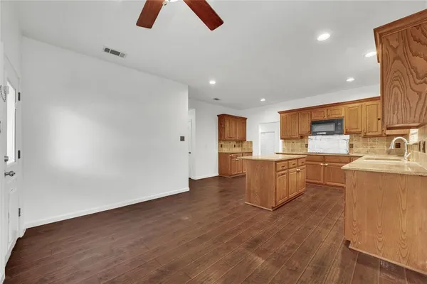 a view of kitchen with furniture and refrigerator