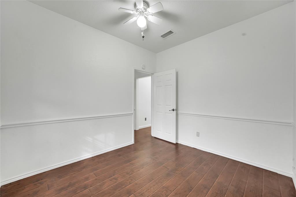 8105 Eagle Drive Rowlett, TX 75088 - Photo 19 of 35 an empty room with wooden floor and fan