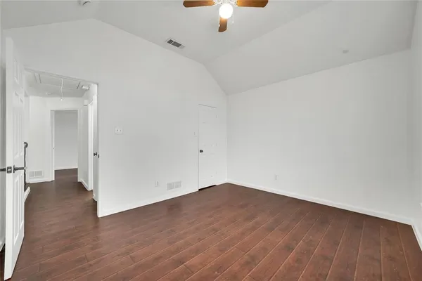 a view of a room with wooden floor
