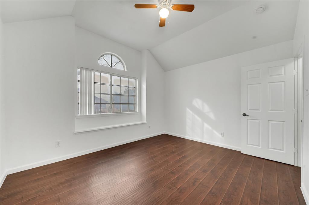 8105 Eagle Drive Rowlett, TX 75088 - Photo 21 of 35 an empty room with wooden floor cabinet and windows