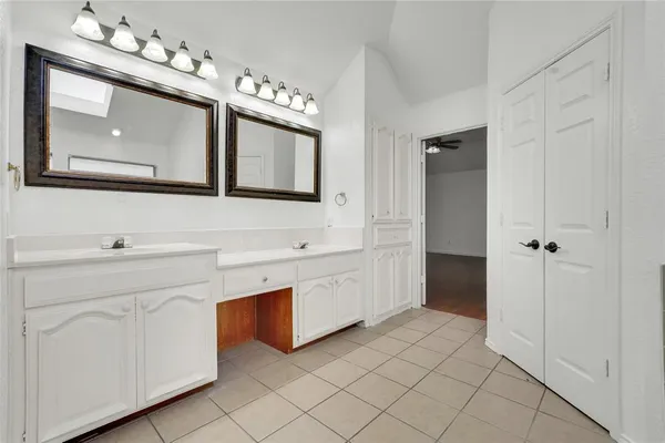 a spacious bathroom with a double vanity sink mirror and