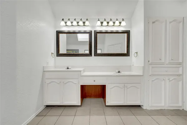 a bathroom with a sink vanity and mirror