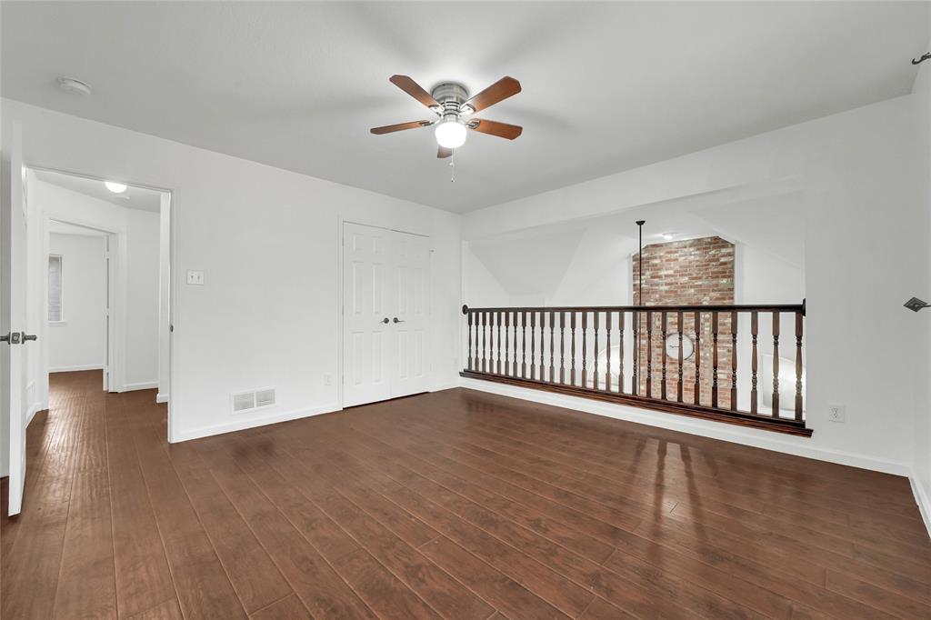 8105 Eagle Drive Rowlett, TX 75088 - Photo 31 of 35 an empty room with wooden floor and windows