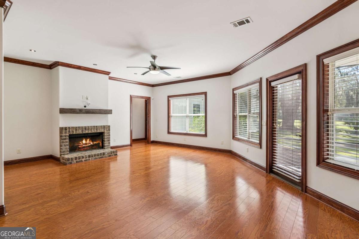 150 Rice Mill St. Simons Island, GA 31522 - Photo 11 of 38 a view of an empty room with window and wooden floor
