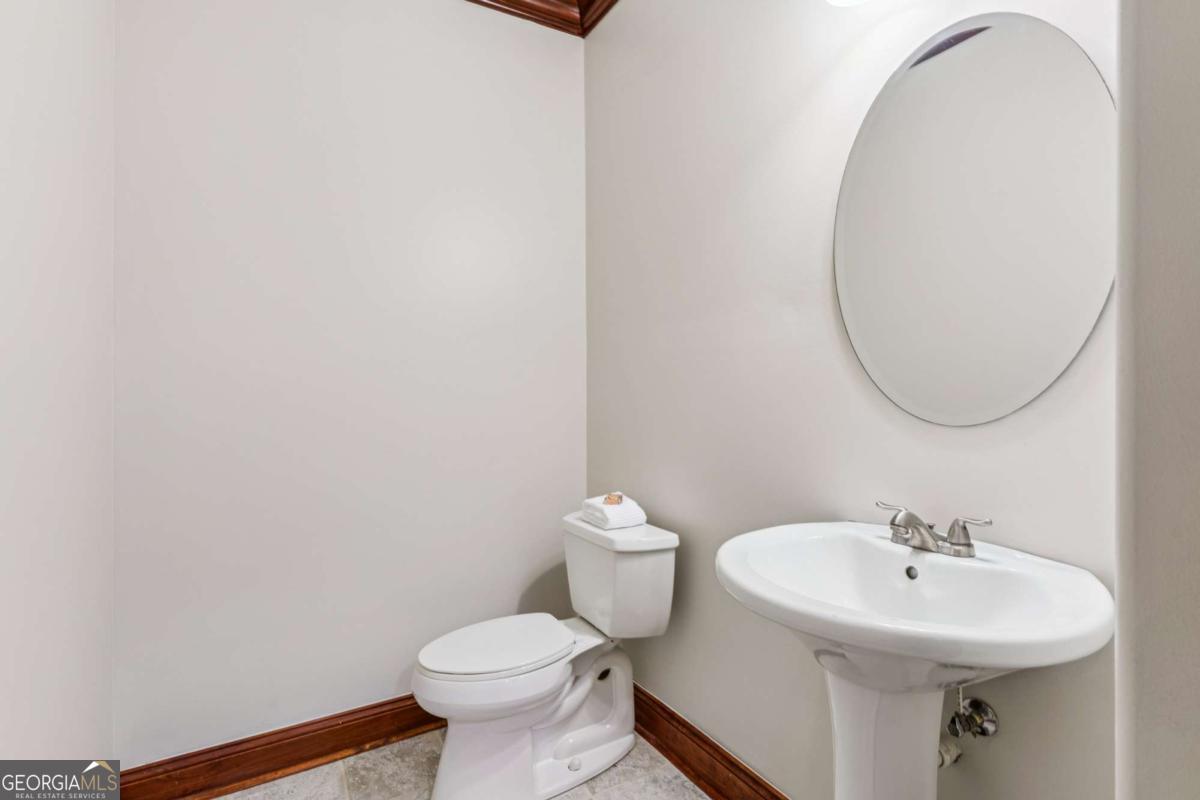 150 Rice Mill St. Simons Island, GA 31522 - Photo 12 of 38 a bathroom with a sink a toilet and a mirror
